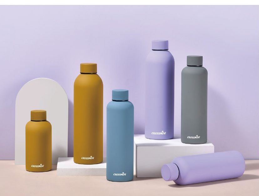 CROSSMUG pastel matte vacuum bottles arranged in a studio scene